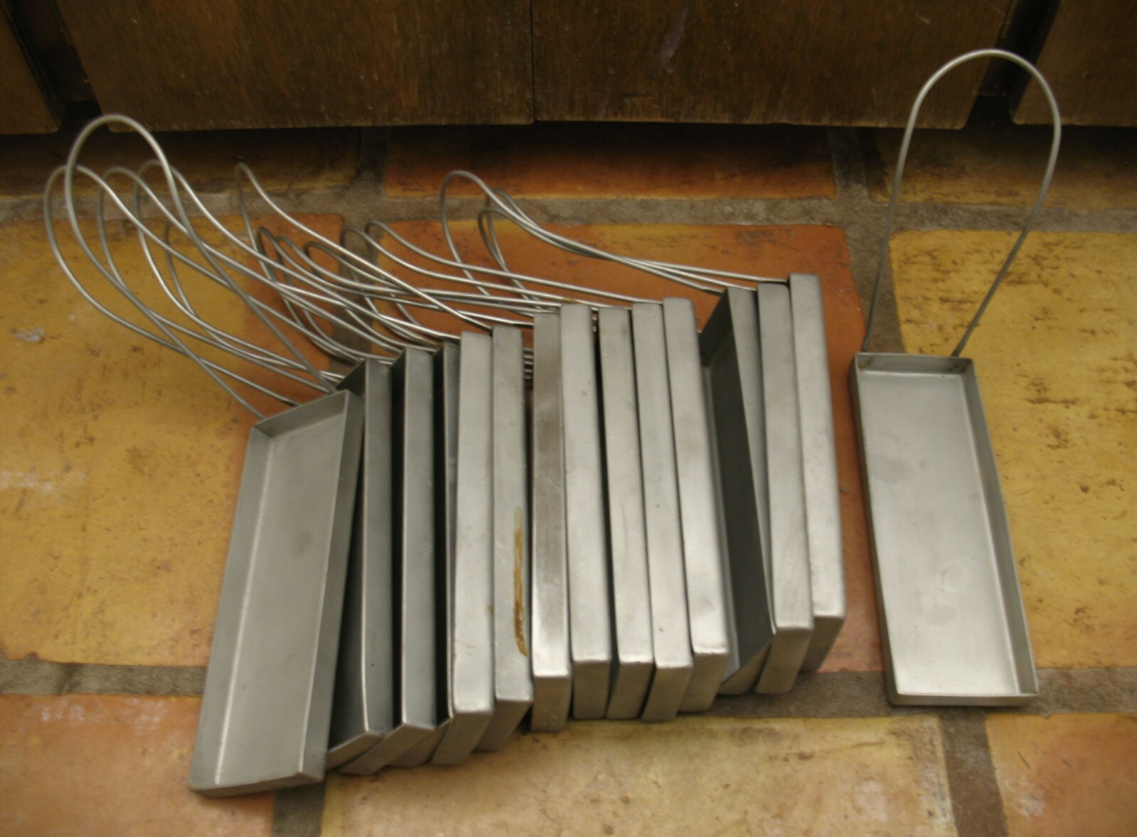 F24 – LOT OF 15 STAINLESS NARROW HANGING TRAYS MEDICAL TOOL HOLDERS (?)
